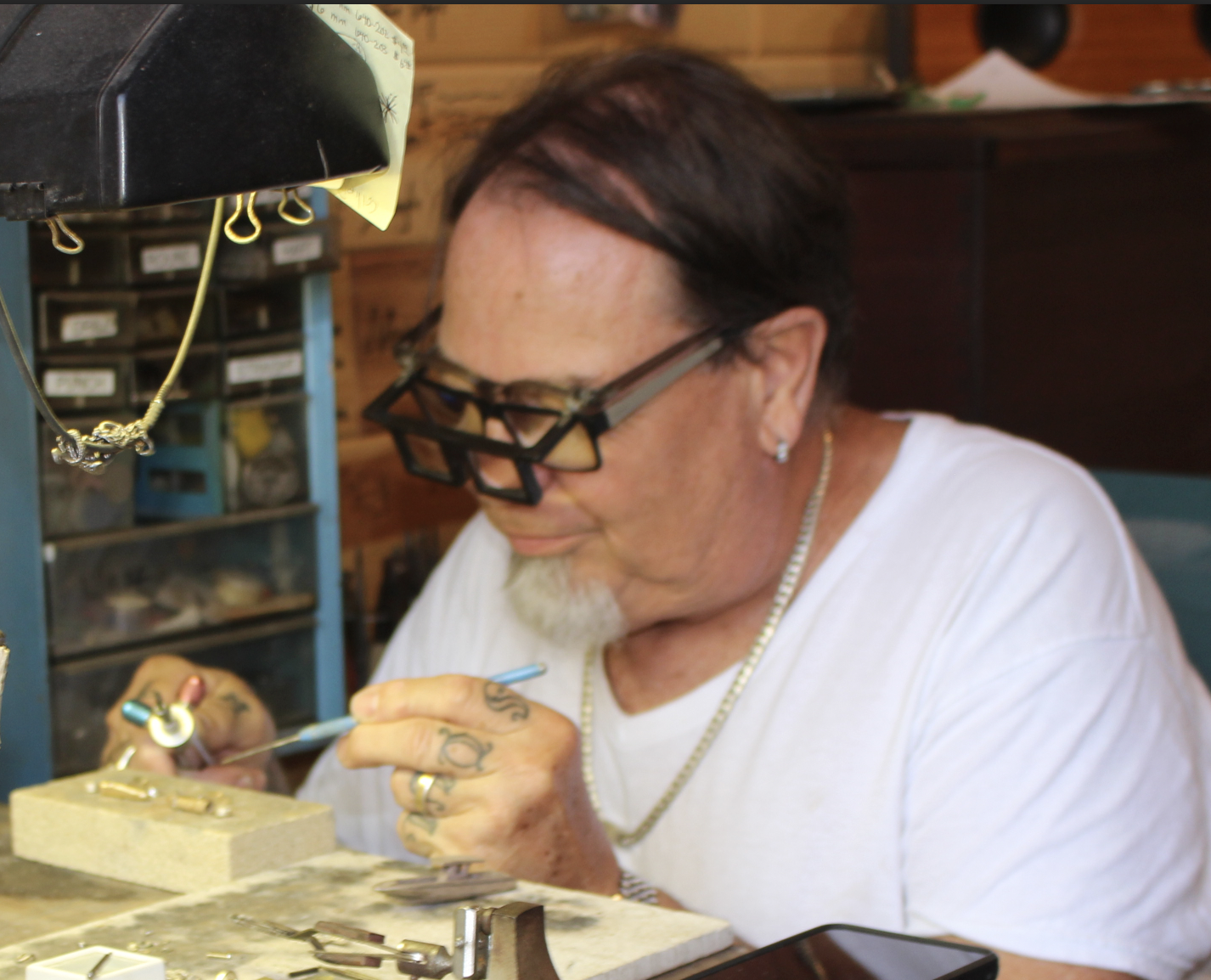 A picture of Matthew working in the jewelry shop.