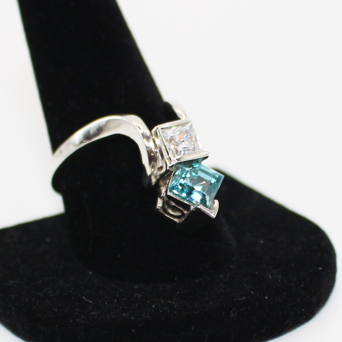 A silver ring with a turquoise stone.