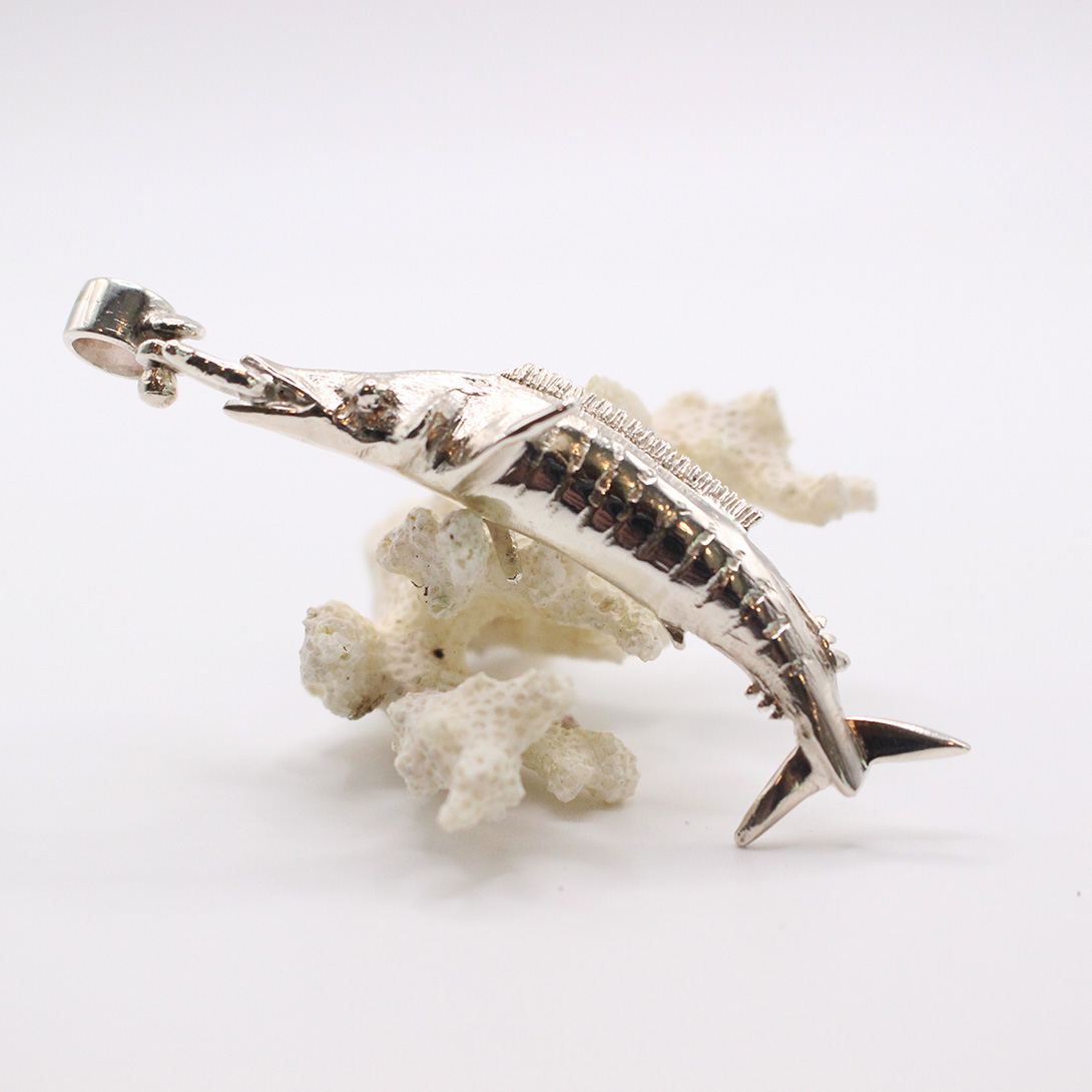 A picture of a sterling silver wahoo pendant.